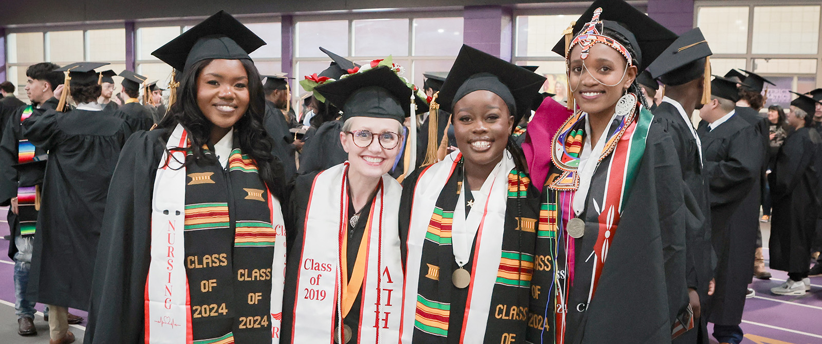 A group of international students in graduation regalia