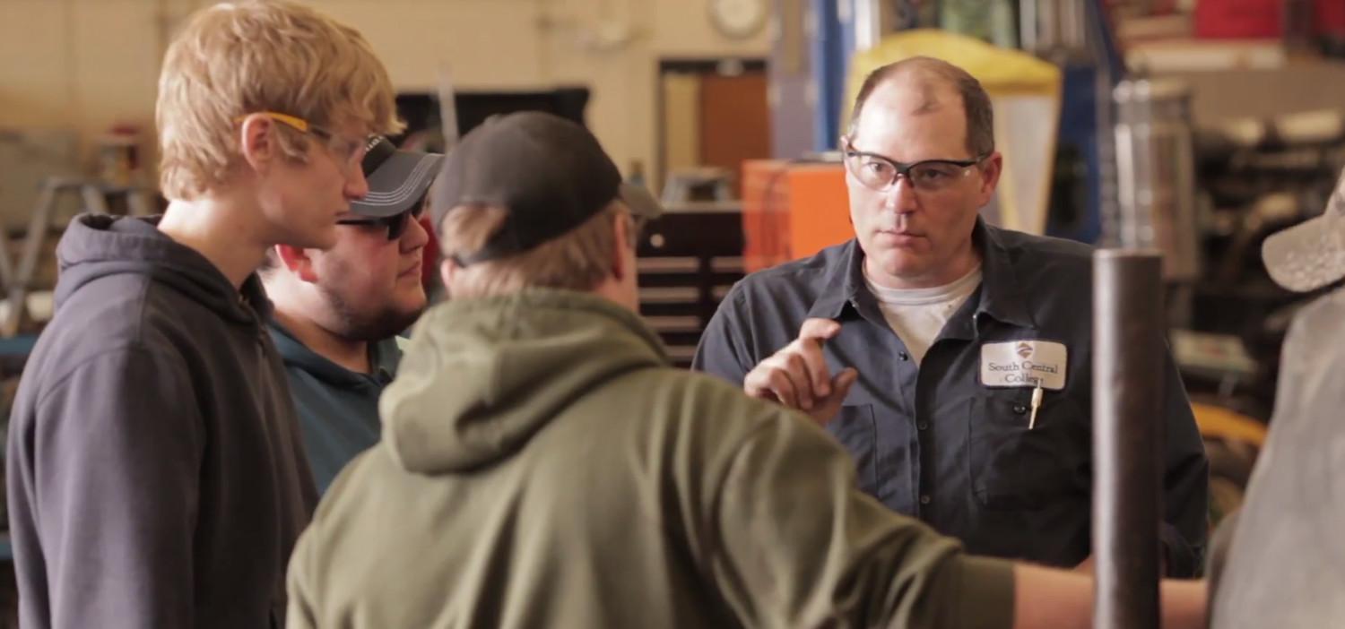 Photo of student and tractor