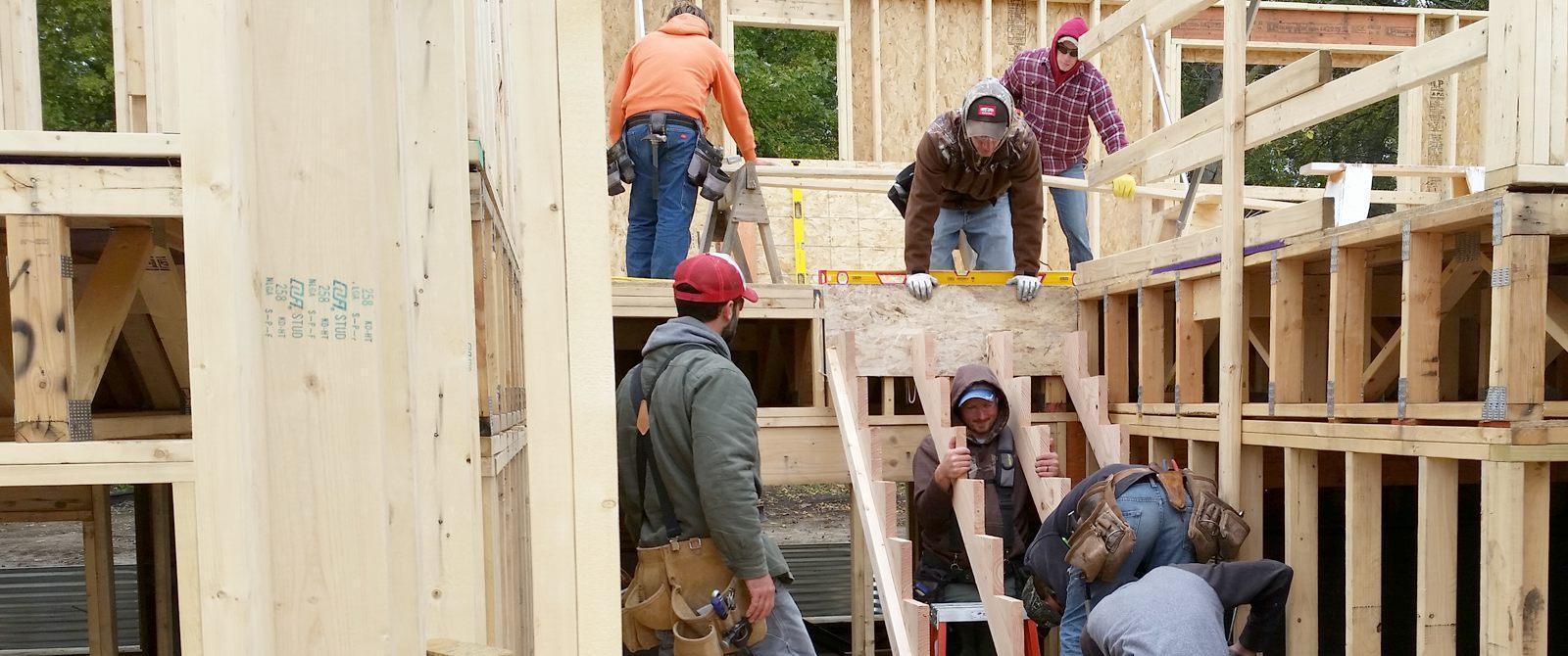 Photo of carpentry students building a house