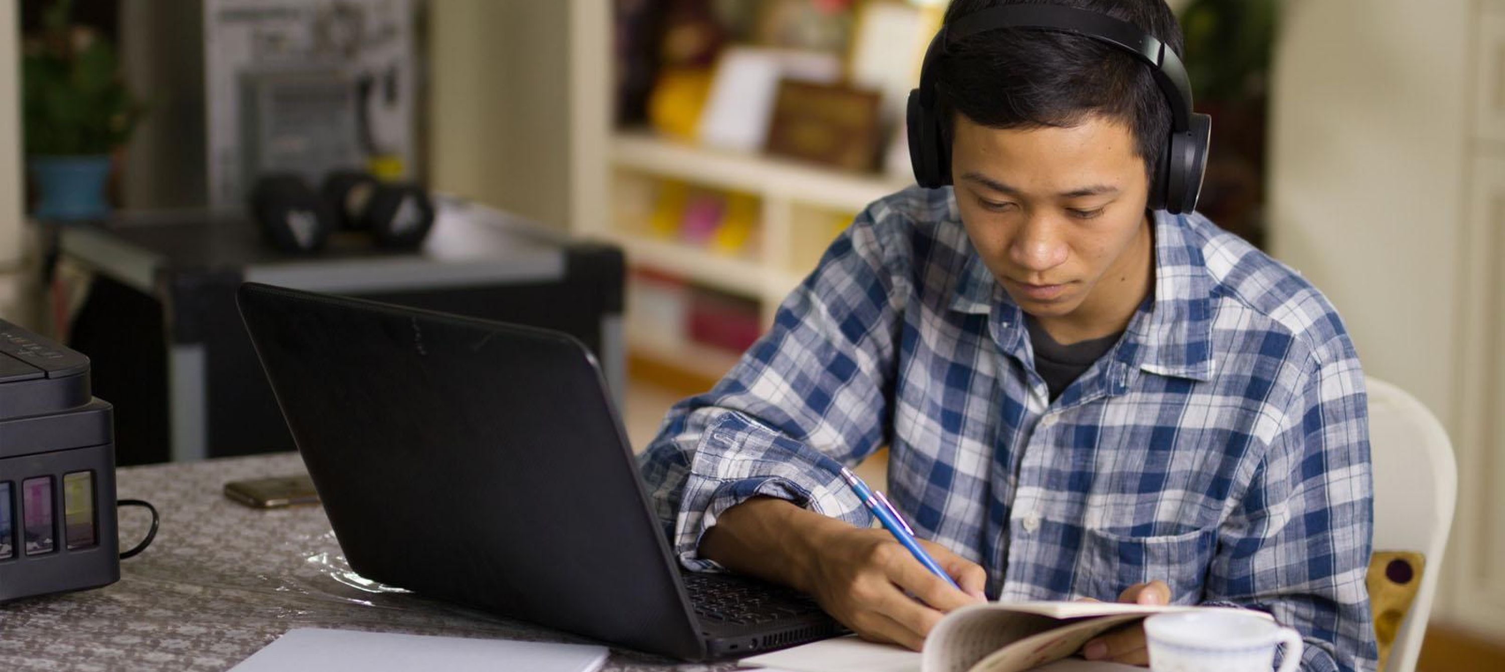 Photo of adult learner studying at home on laptop computer