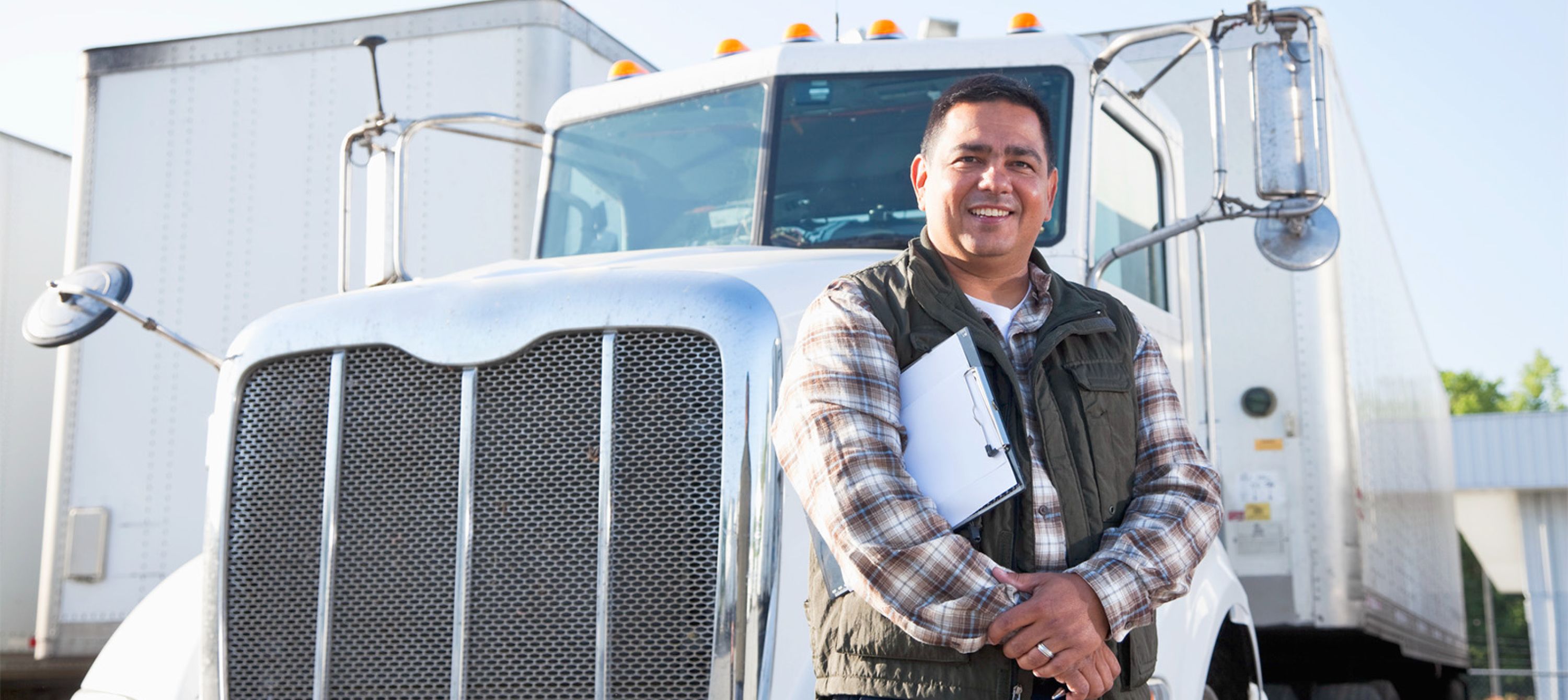 Student Driver standing in front of semi-truck