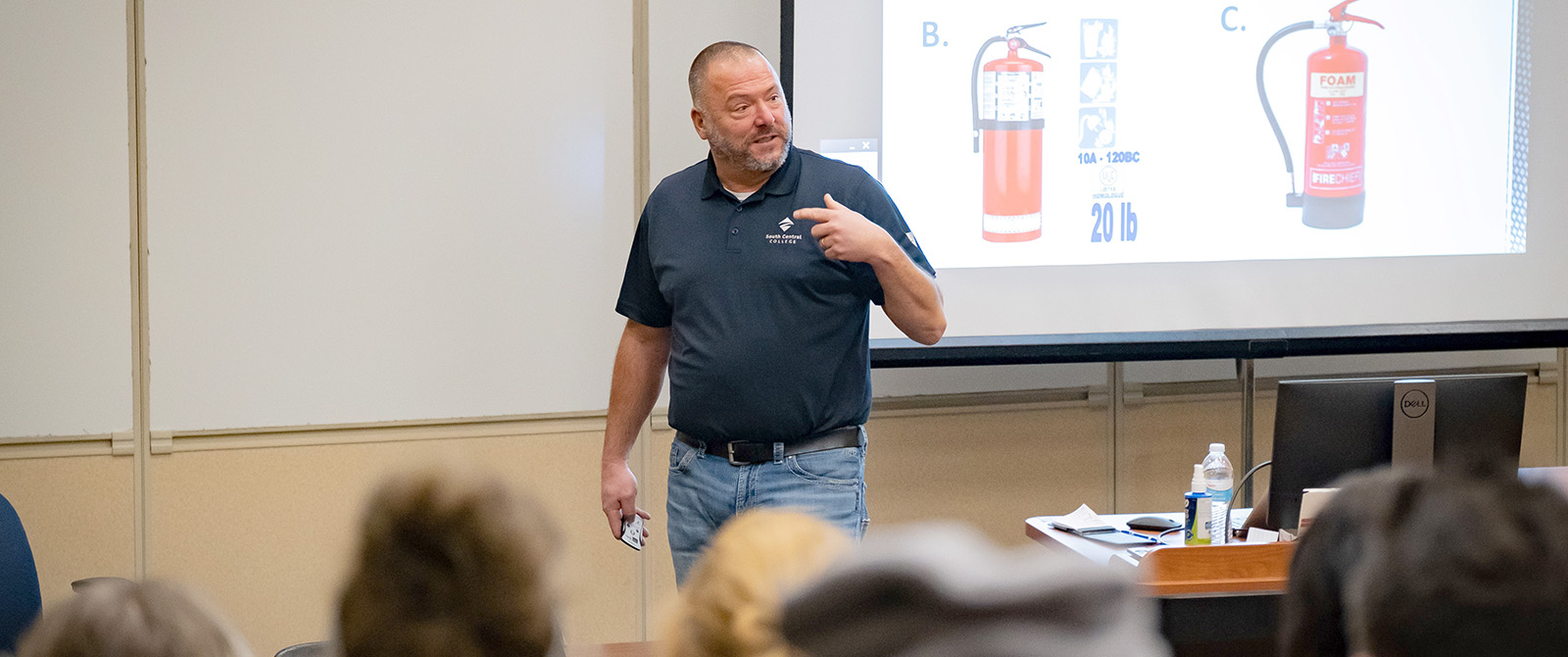OSHA instructor presenting slide in a training room.