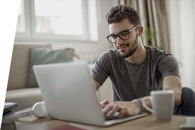 Male student using laptop
