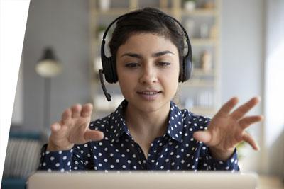 Student wearing headset talking with online class