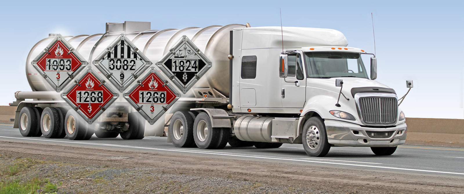 Semi Truck driving down highway with safety placards for hazardous materials superimposed over the truck.