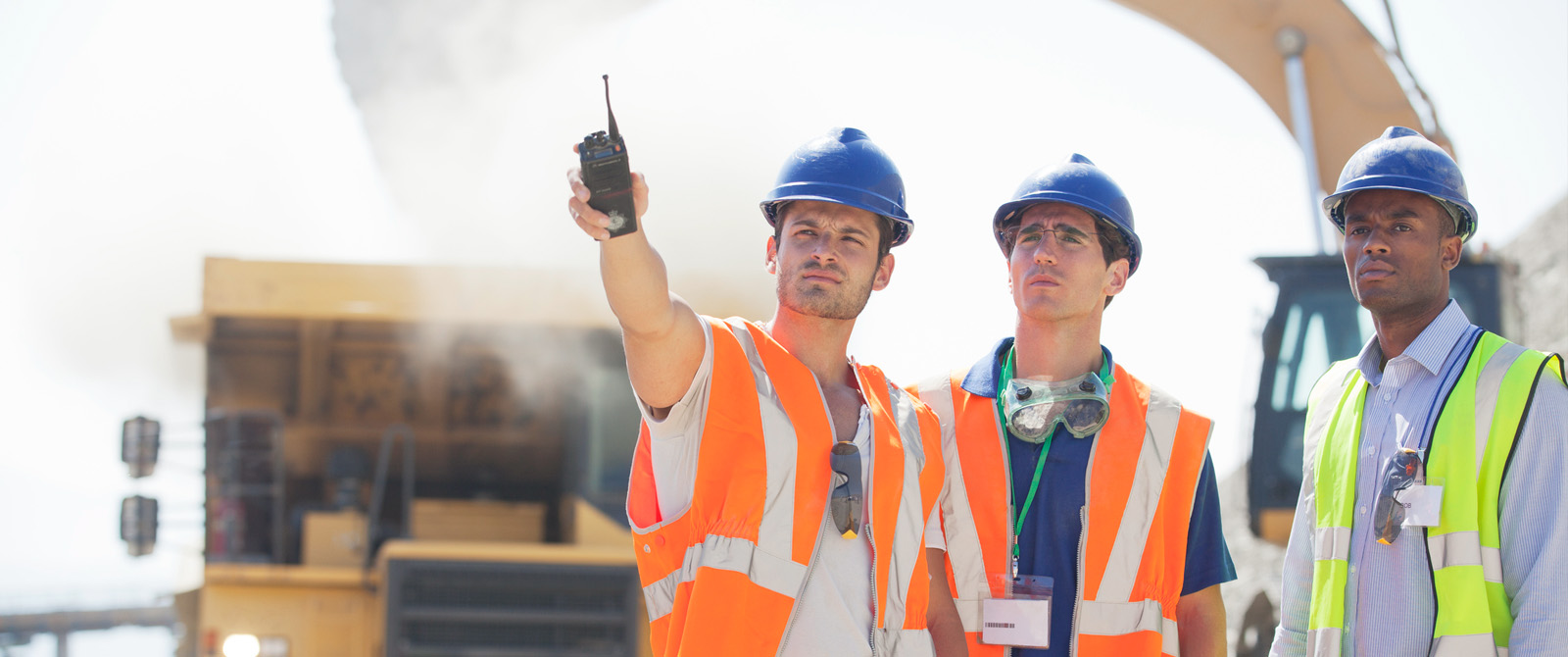 Photo of workers at a surface mining operation wearing hard hats and high visibility vests