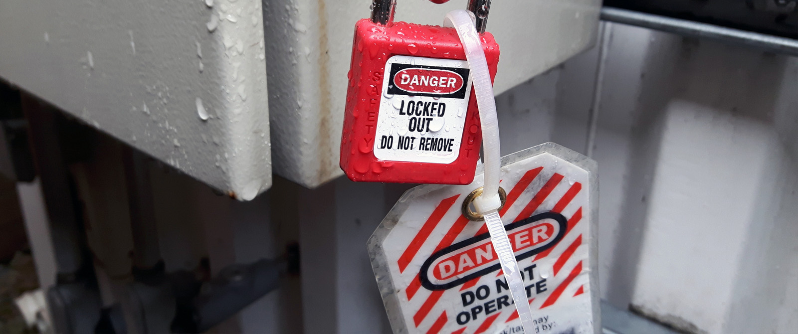 Photograph of Lockout Tagout lock and tags warning that the equipment should not be used.